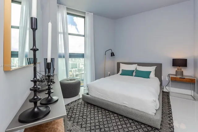 a bedroom with a bed window and a lamp