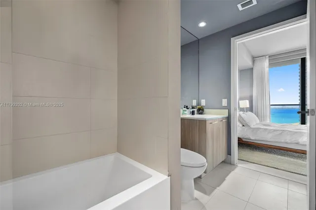 a bathroom with a sink a toilet a mirror and shower