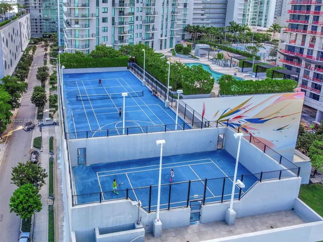 a swimming pool with a pool table and chairs
