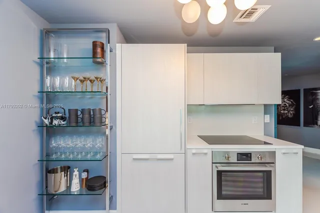 a dining room with furniture and a chandelier