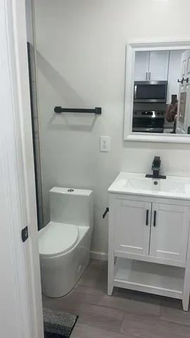 a kitchen with a refrigerator and white cabinets