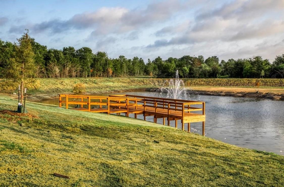 14762 Childress Rnch Drive Washington, TX 77880 - Photo 11 of 13 a view of a lake with houses in the back