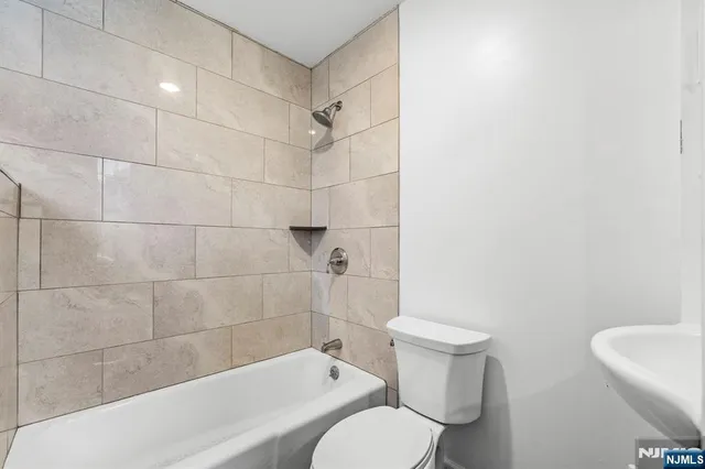 a bathroom with a toilet and shower