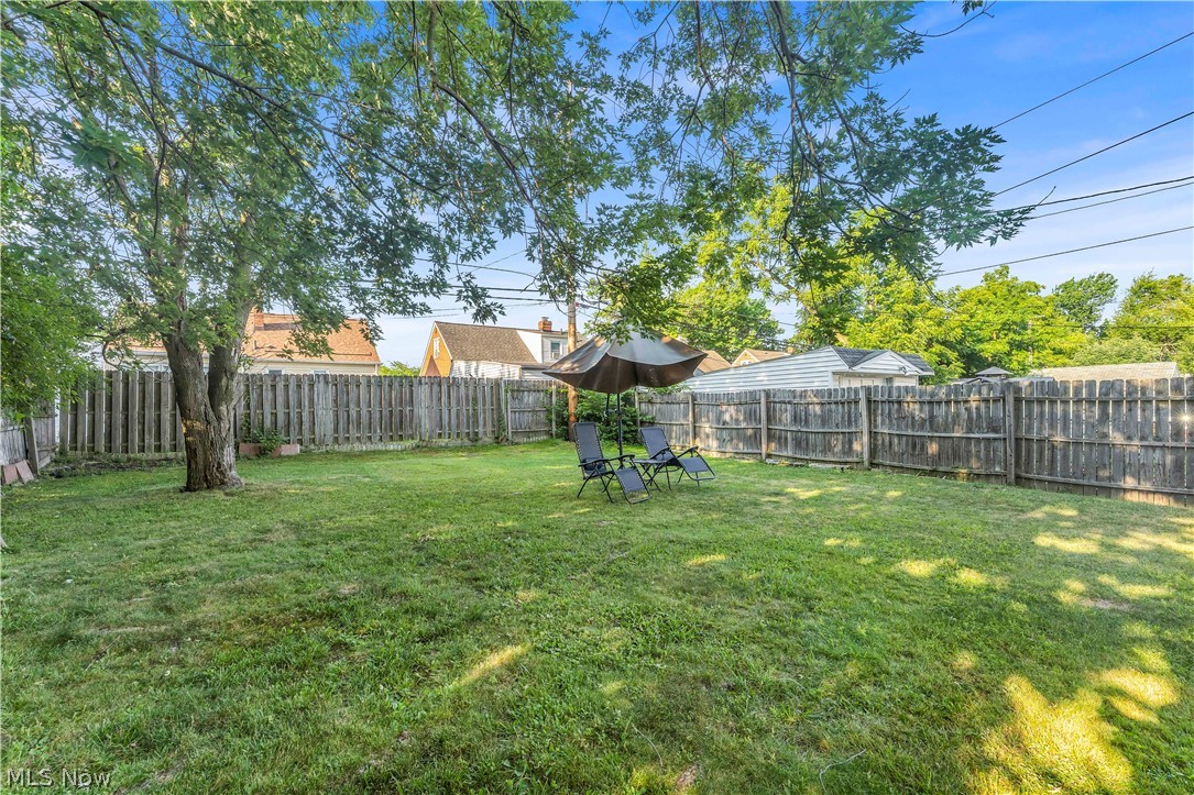 3962 Grosvenor Road South Euclid, OH 44118 - Photo 25 of 27 Expansive backyard featuring a manicured lawn, established mature trees, and a full privacy fence