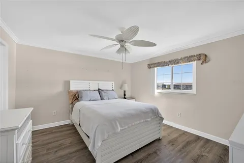 a bedroom with a bed and a ceiling fan