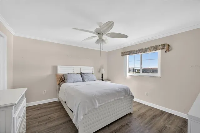 a bedroom with a bed and a ceiling fan