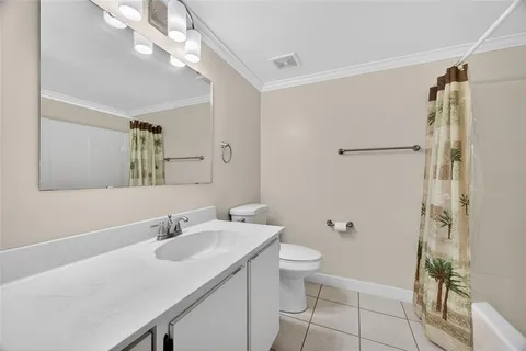 a bathroom with a sink toilet a mirror and shower
