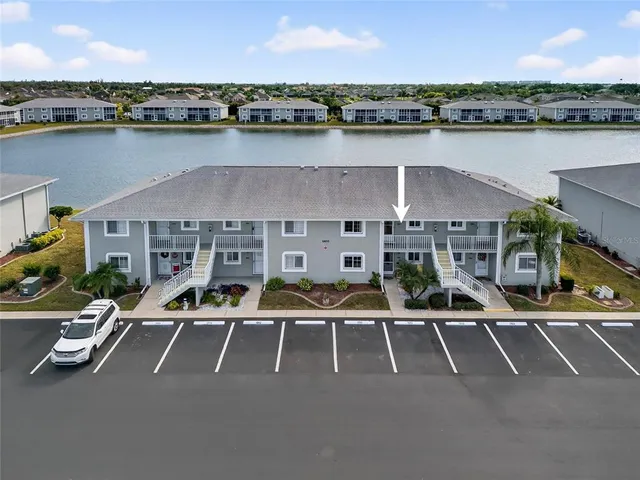 an aerial view of a house with swimming pool and lawn chairs