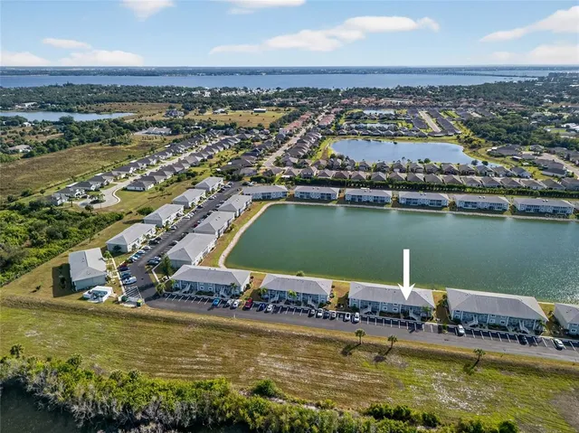 an aerial view of a city with a lake