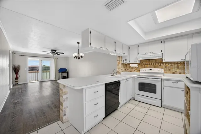 a kitchen with cabinets stainless steel appliances a sink and a counter top space
