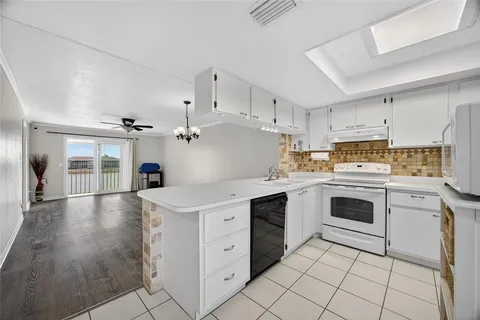 a kitchen with cabinets stainless steel appliances a sink and a counter top space