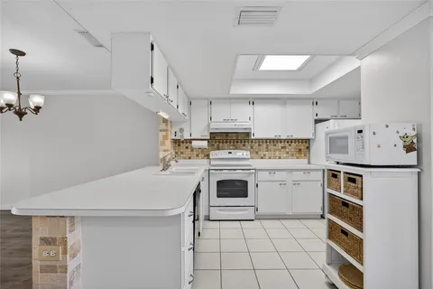 a kitchen with a stove a sink dishwasher and a refrigerator