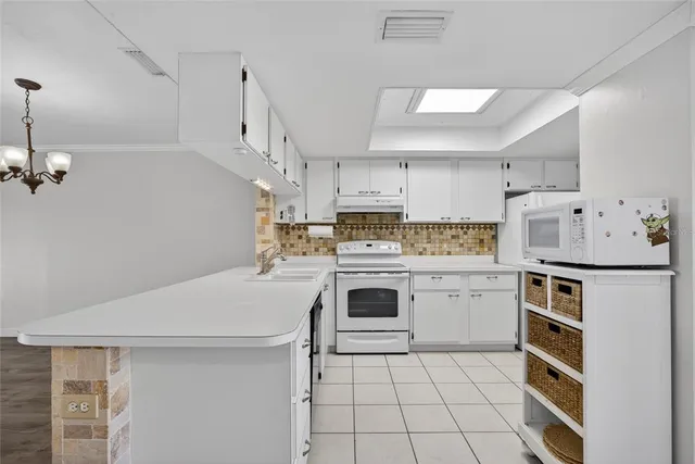 a kitchen with a stove a sink dishwasher and a refrigerator