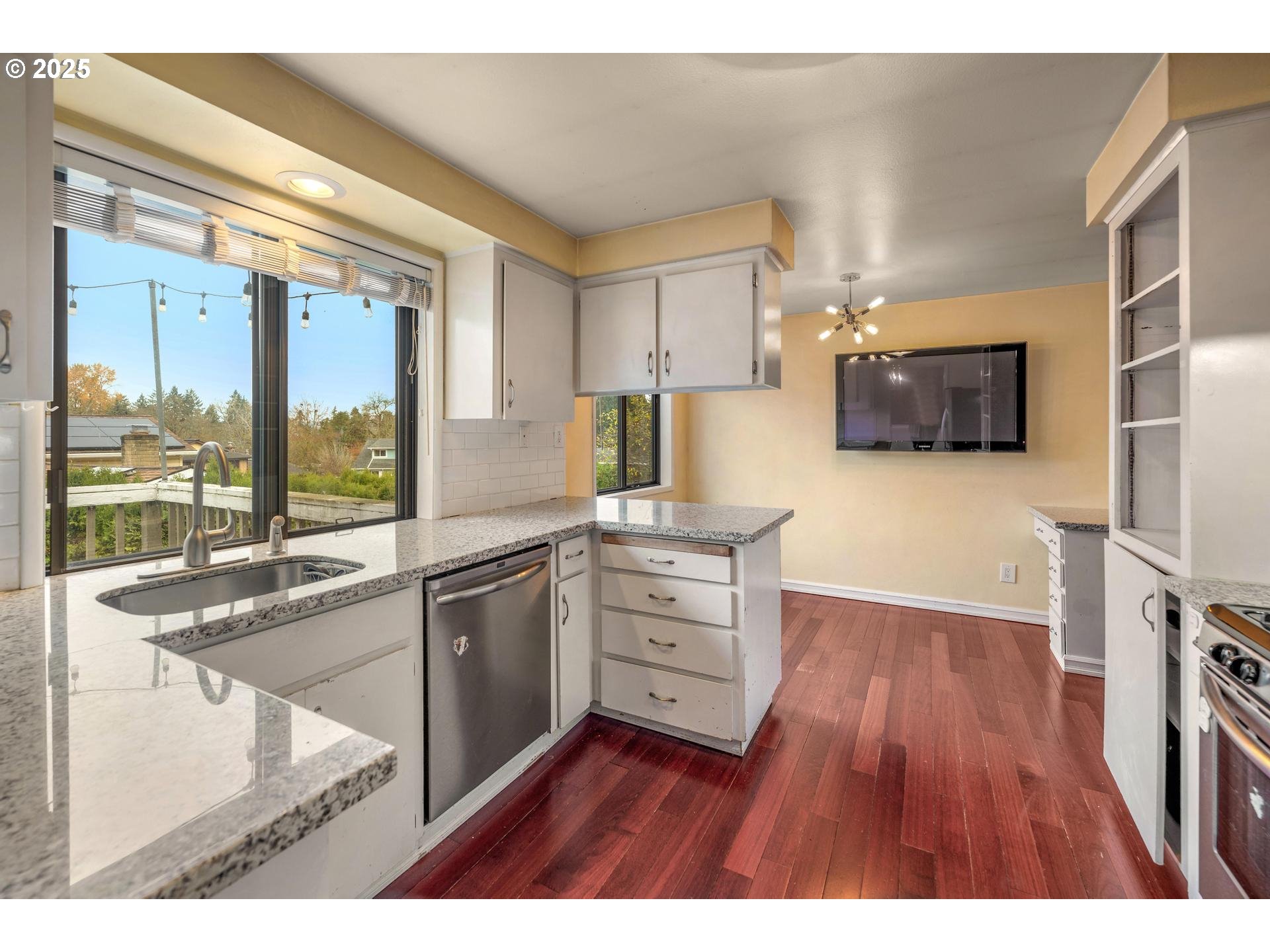 18115 Southwest Broad Oak Boulevard Beaverton, OR 97007 - Photo 14 of 43 a kitchen with stainless steel appliances granite countertop a stove a sink and a refrigerator