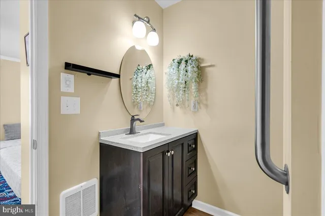 a bathroom with a sink a mirror and vanity