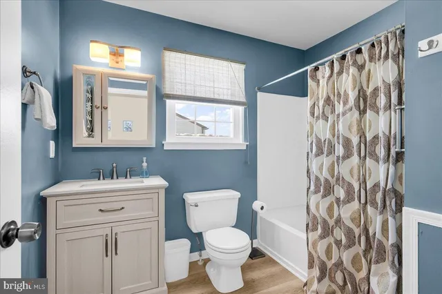 a bathroom with a sink toilet and a mirror