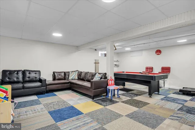 a living room with furniture and a rug