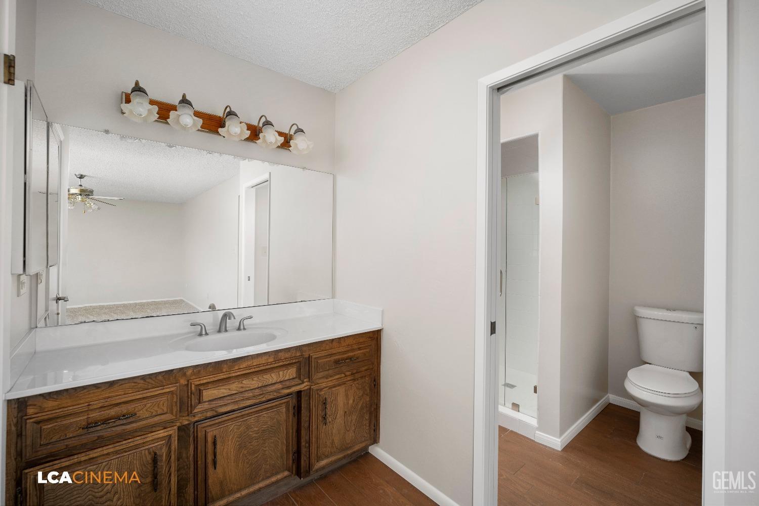 Undisclosed Address Bakersfield, CA 93309 - Photo 18 of 22 a bathroom with a toilet sink and mirror