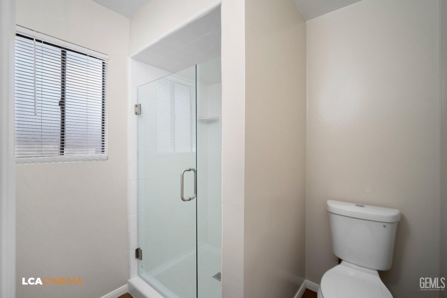 Undisclosed Address Bakersfield, CA 93309 - Photo 19 of 22 a bathroom with a toilet and shower
