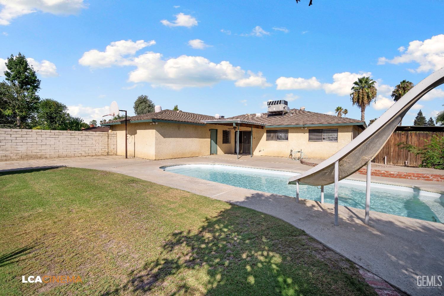 Undisclosed Address Bakersfield, CA 93309 - Photo 21 of 22 a swimming pool with yard in front of it