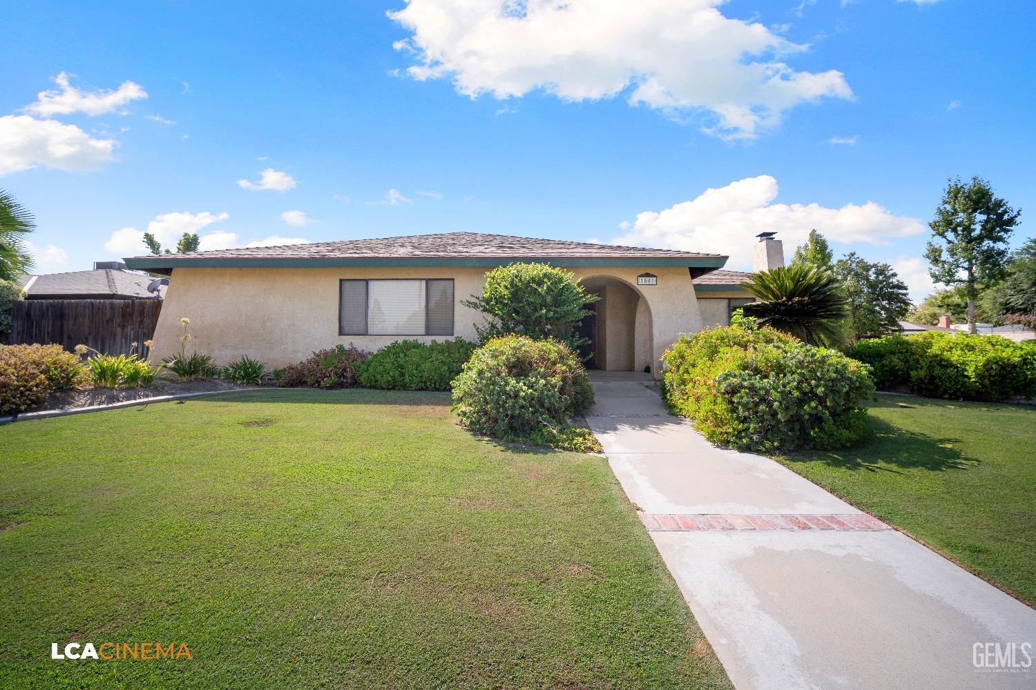Undisclosed Address Bakersfield, CA 93309 - Photo 4 of 22 a front view of house with yard and green space