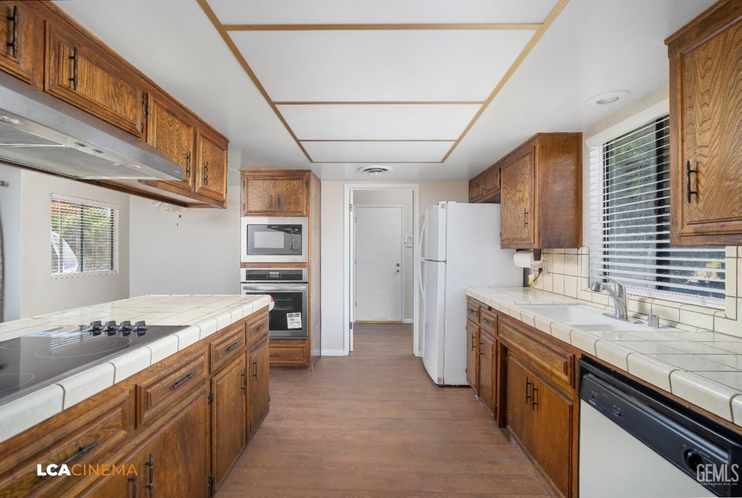 Undisclosed Address Bakersfield, CA 93309 - Photo 8 of 22 a large kitchen with stainless steel appliances granite countertop a sink stove and refrigerator