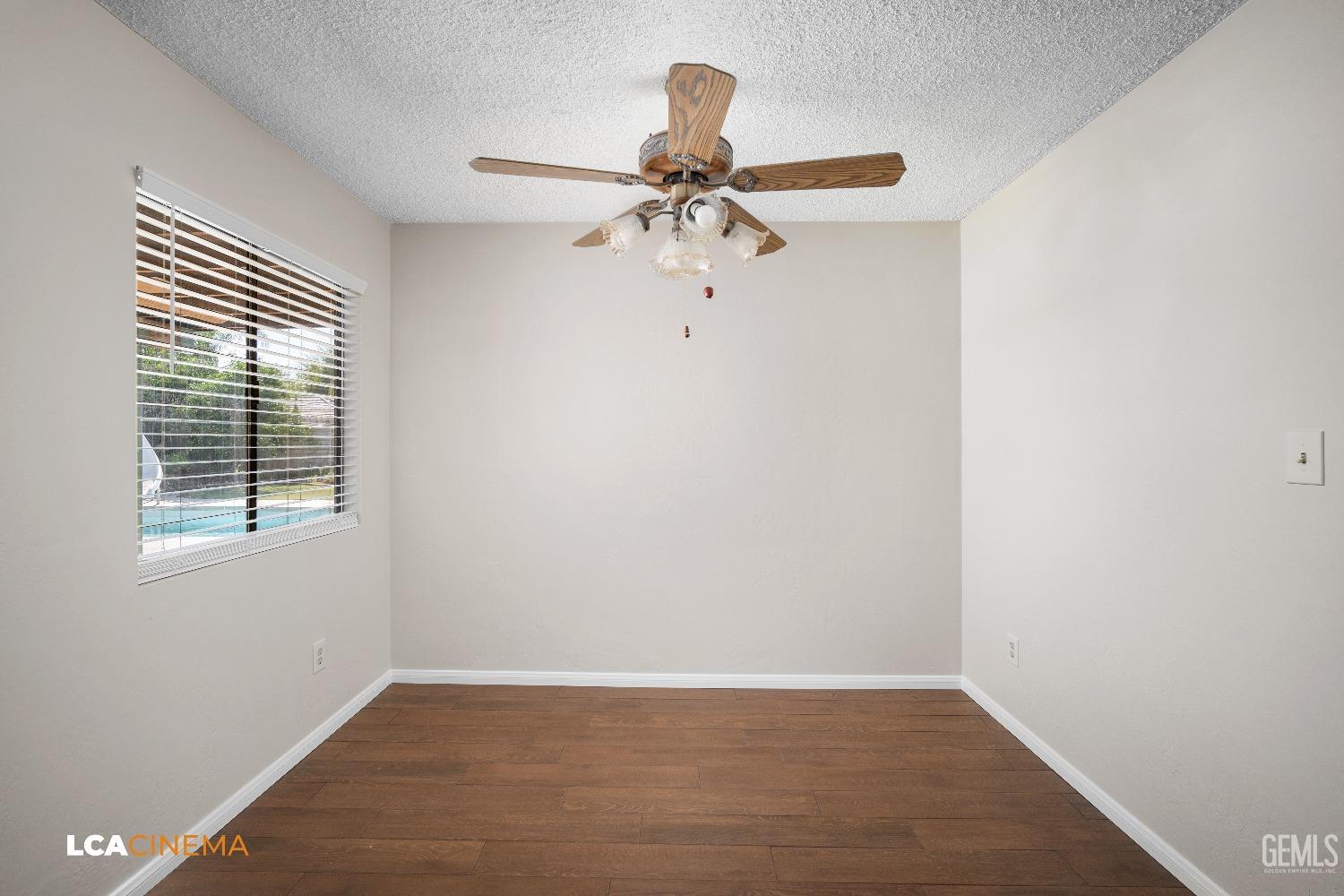 Undisclosed Address Bakersfield, CA 93309 - Photo 9 of 22 wooden floor in an empty room with a window