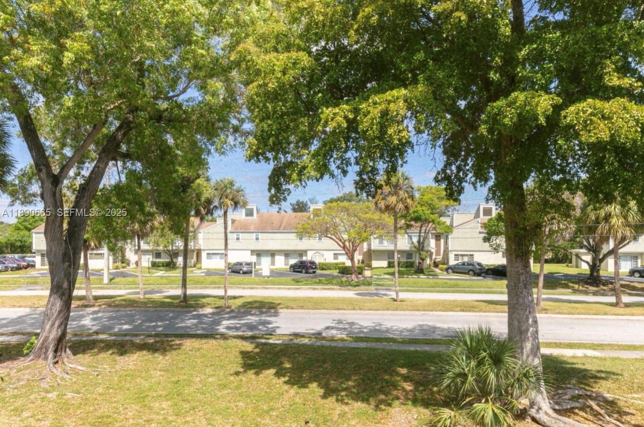 8060 North Colony Circle, Unit 207 Tamarac, FL 33321 - Photo 12 of 14 a view of a yard with swimming pool