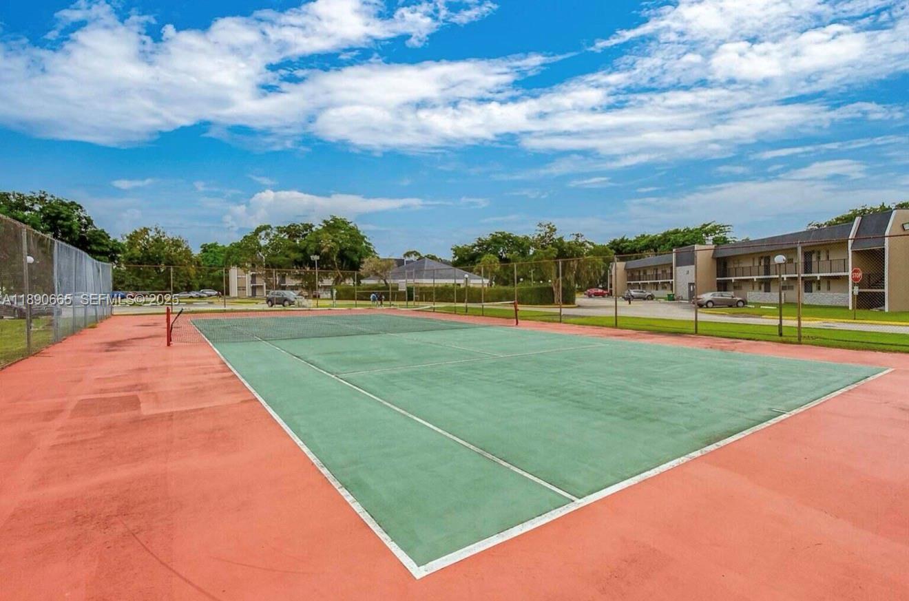 8060 North Colony Circle, Unit 207 Tamarac, FL 33321 - Photo 14 of 14 a view of building with a big yard