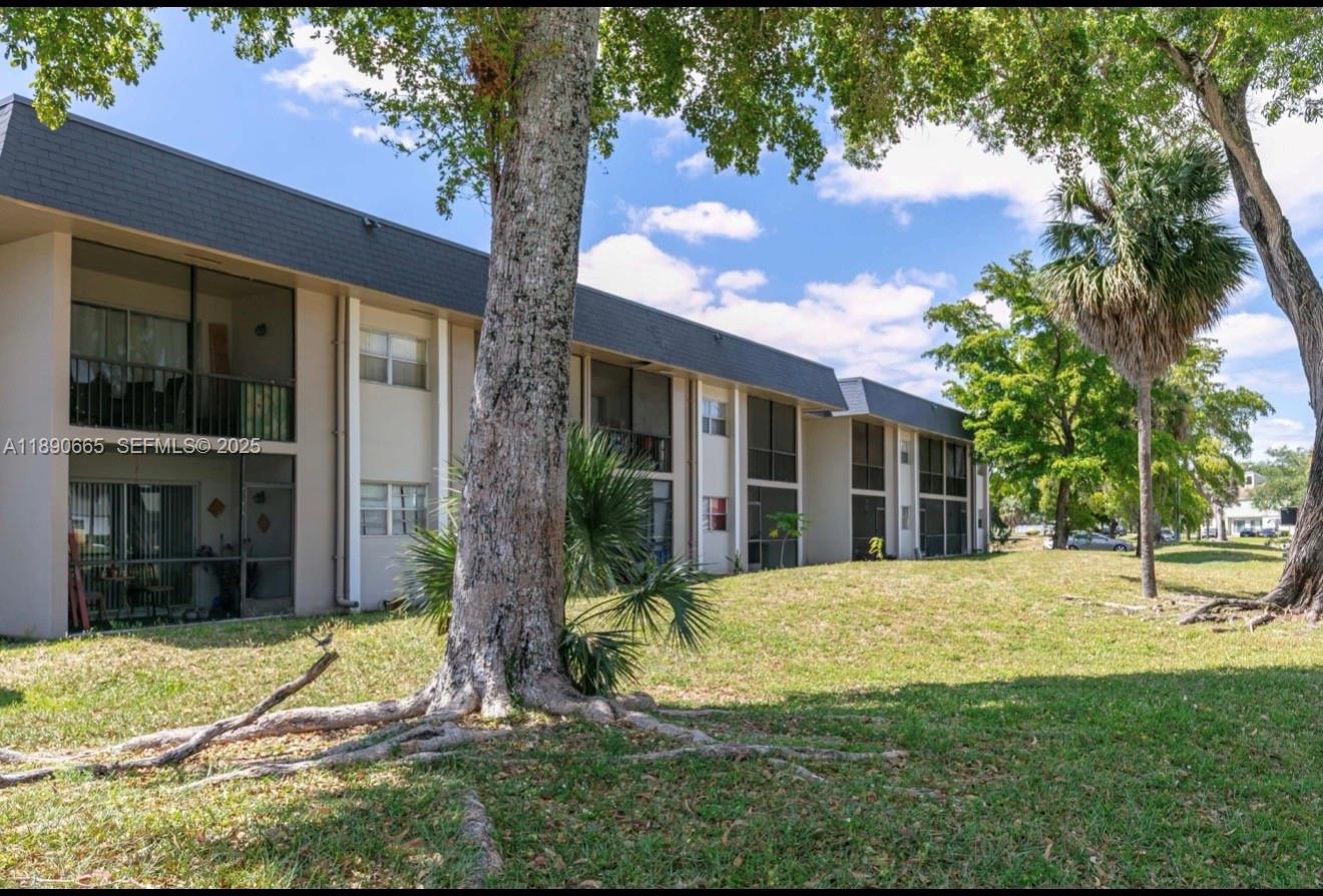 8060 North Colony Circle, Unit 207 Tamarac, FL 33321 - Photo 2 of 14 a view of a house with yard and tree s