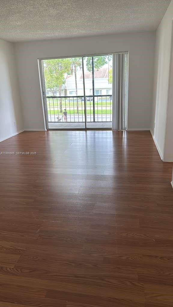 8060 North Colony Circle, Unit 207 Tamarac, FL 33321 - Photo 5 of 14 a view of an empty room with wooden floor and a window