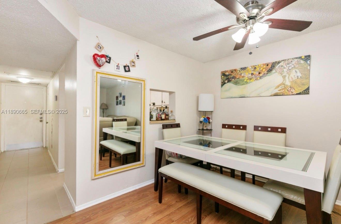 8060 North Colony Circle, Unit 207 Tamarac, FL 33321 - Photo 8 of 14 a view of a dining room with a table and chairs