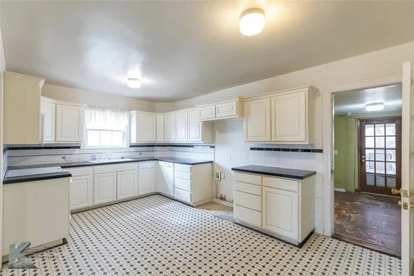 a kitchen with a sink stove and cabinets