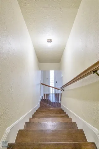 a view of a hallway with stairs