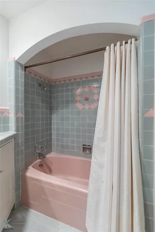 a bathroom with bathtub and shower