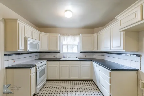 a kitchen with a sink stove and cabinets