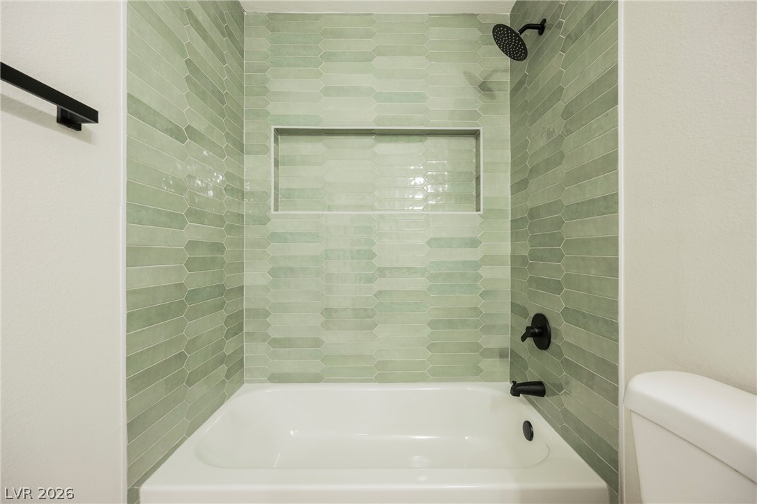 223 West Basic Road Henderson, NV 89015 - Photo 14 of 19 Glistening tilework and modern fixtures define this beautifully updated bath space.
