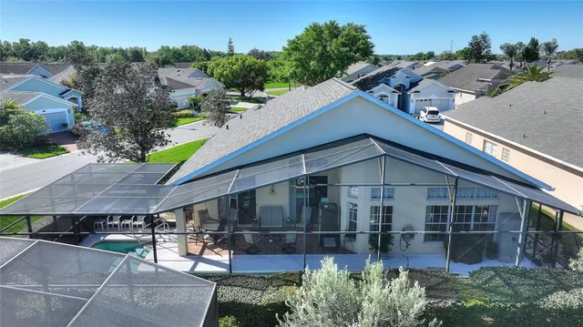 an aerial view of a house with a yard and lake view