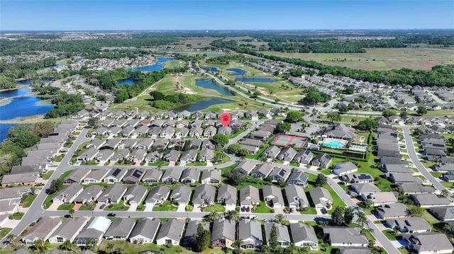 an aerial view of a house a yard swimming pool and outdoor seating