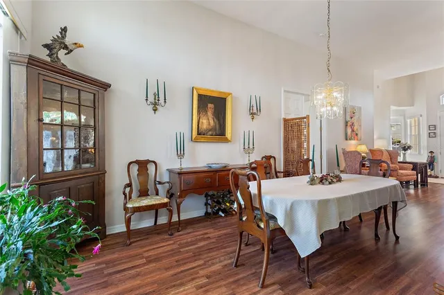 a dining room with furniture a chandelier and window