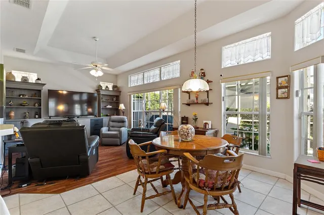 a living room with furniture a chandelier and a flat screen tv