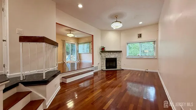 a view of livingroom with hardwood floor and a fireplace