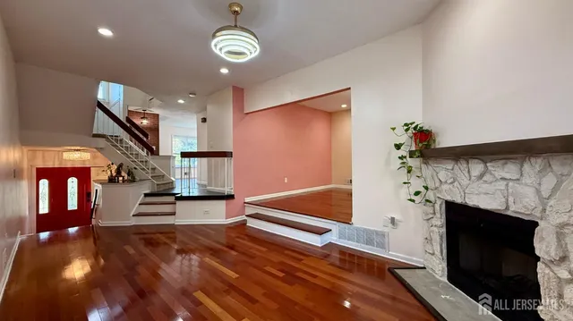 a view of entryway livingroom and hall with wooden floor