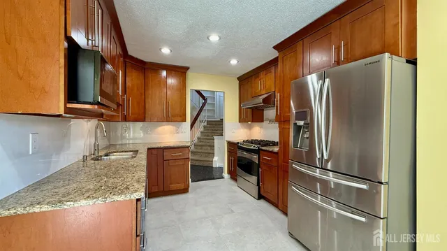 a kitchen with refrigerator and cabinets