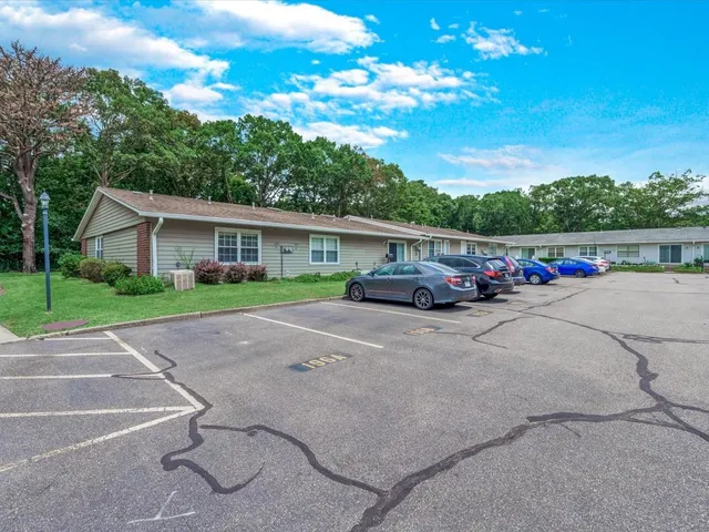a car parked beside a road next to a building