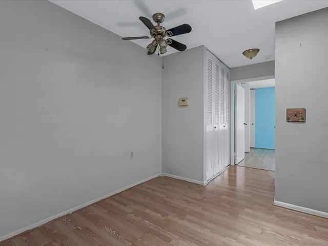 a view of an empty room and wooden floor