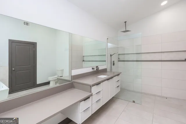 a bathroom with a shower and vanity