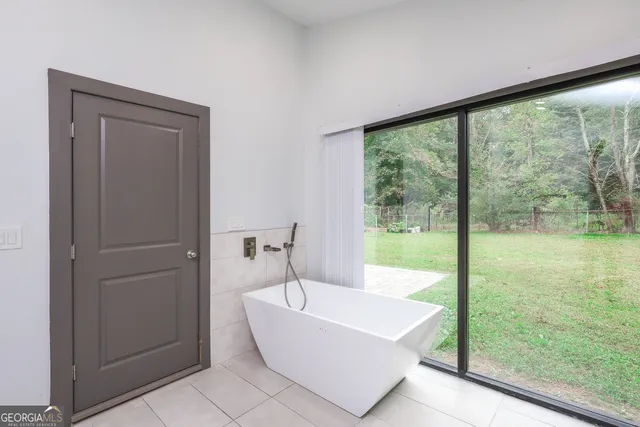 an empty room with a window and a ceiling fan