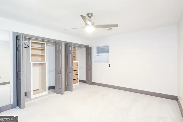 an empty room with walk in closet and window