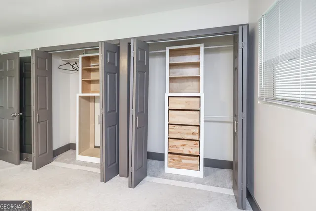 a view of a livingroom with a ceiling fan and wooden floor